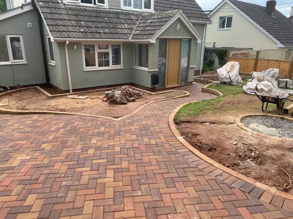 a brick walkway next to a house