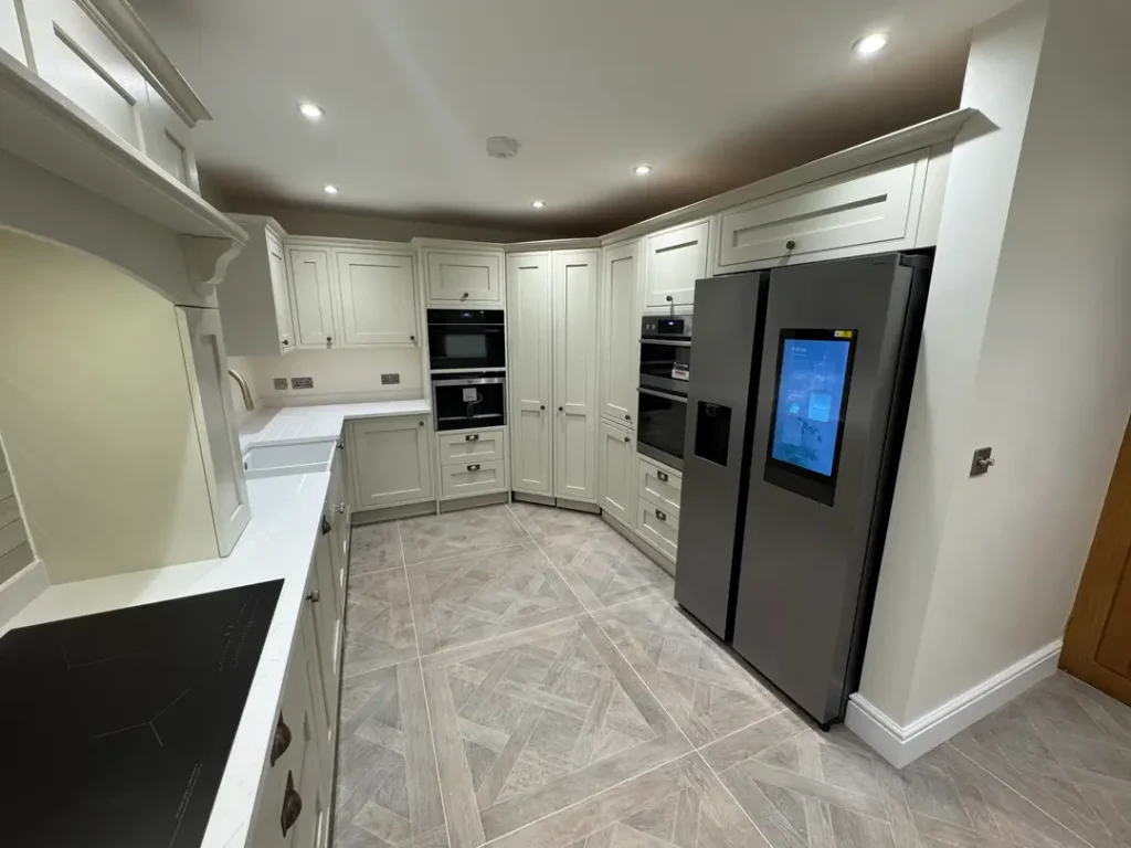 a kitchen with white cabinets and a refrigerator